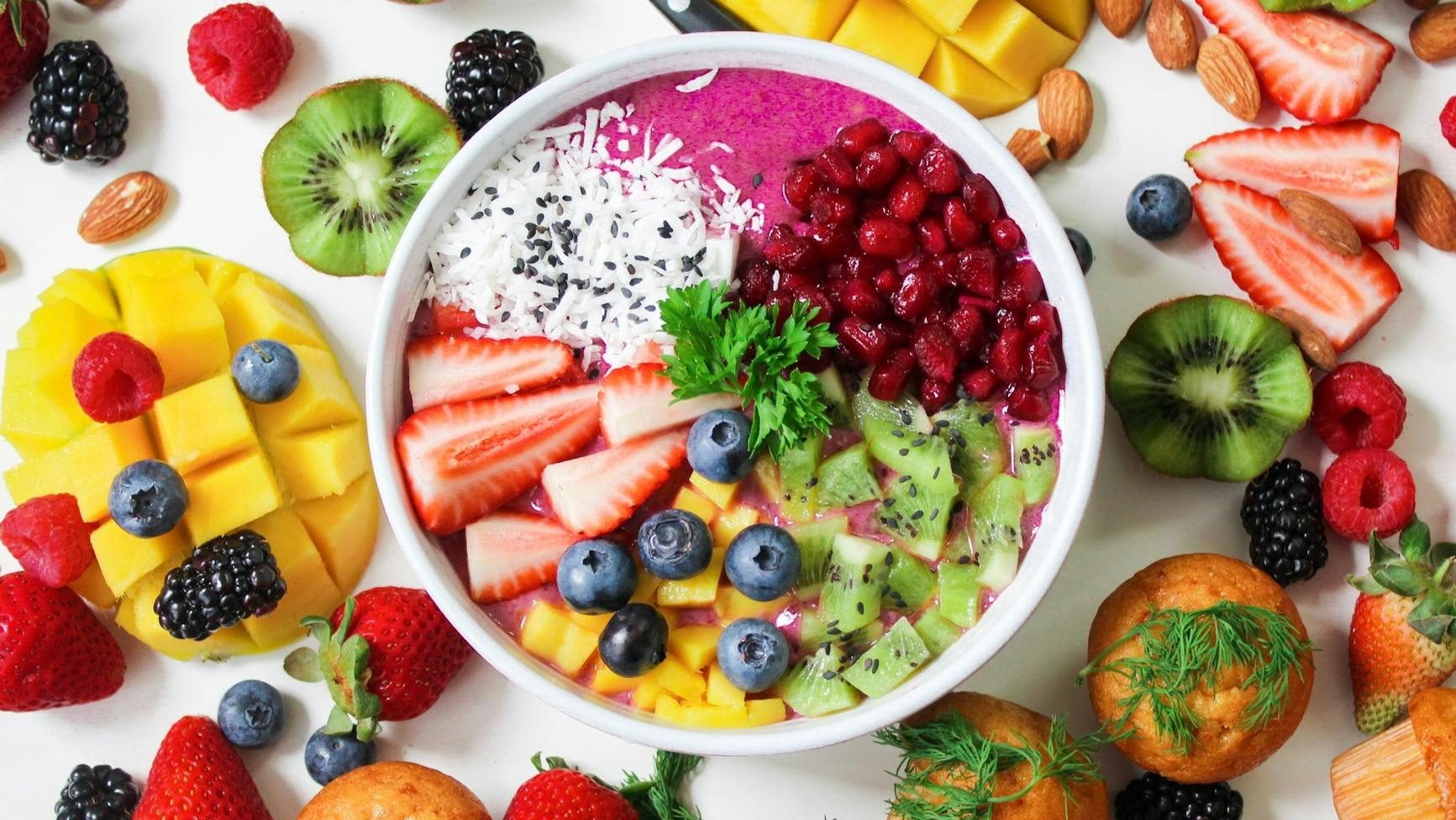 assorted sliced fruits in white ceramic bowl