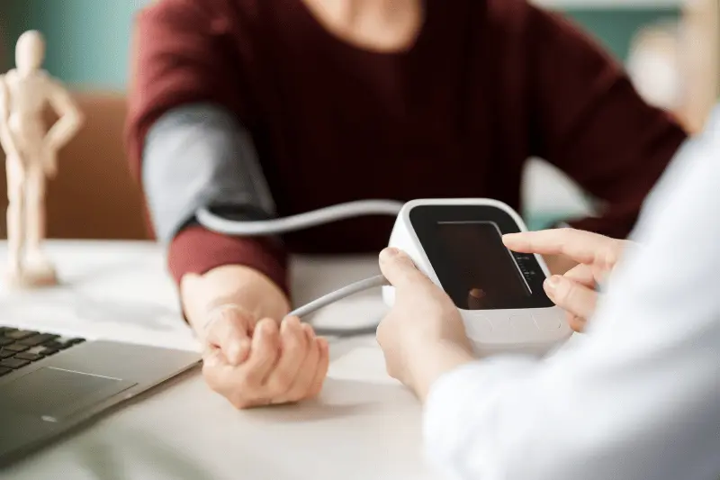 Primary care doctor checking a patient's blood pressure in Albuquerque